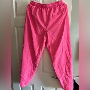 Pink parachute material joggers.